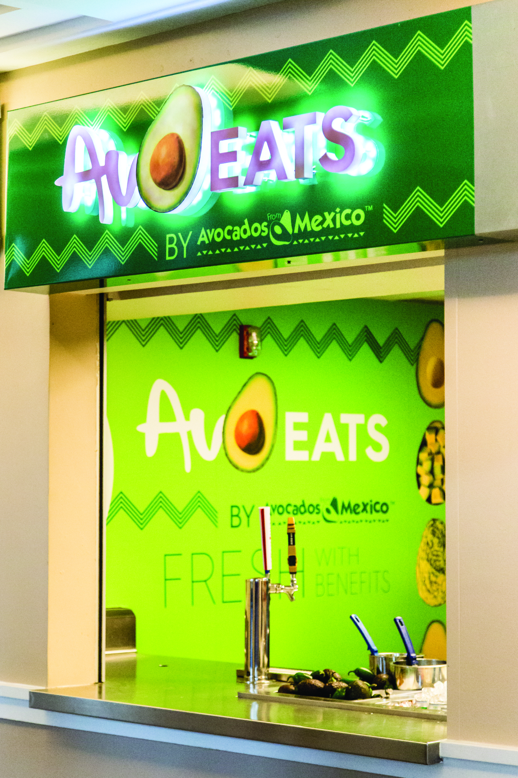 AvoEats stand wall art and signage