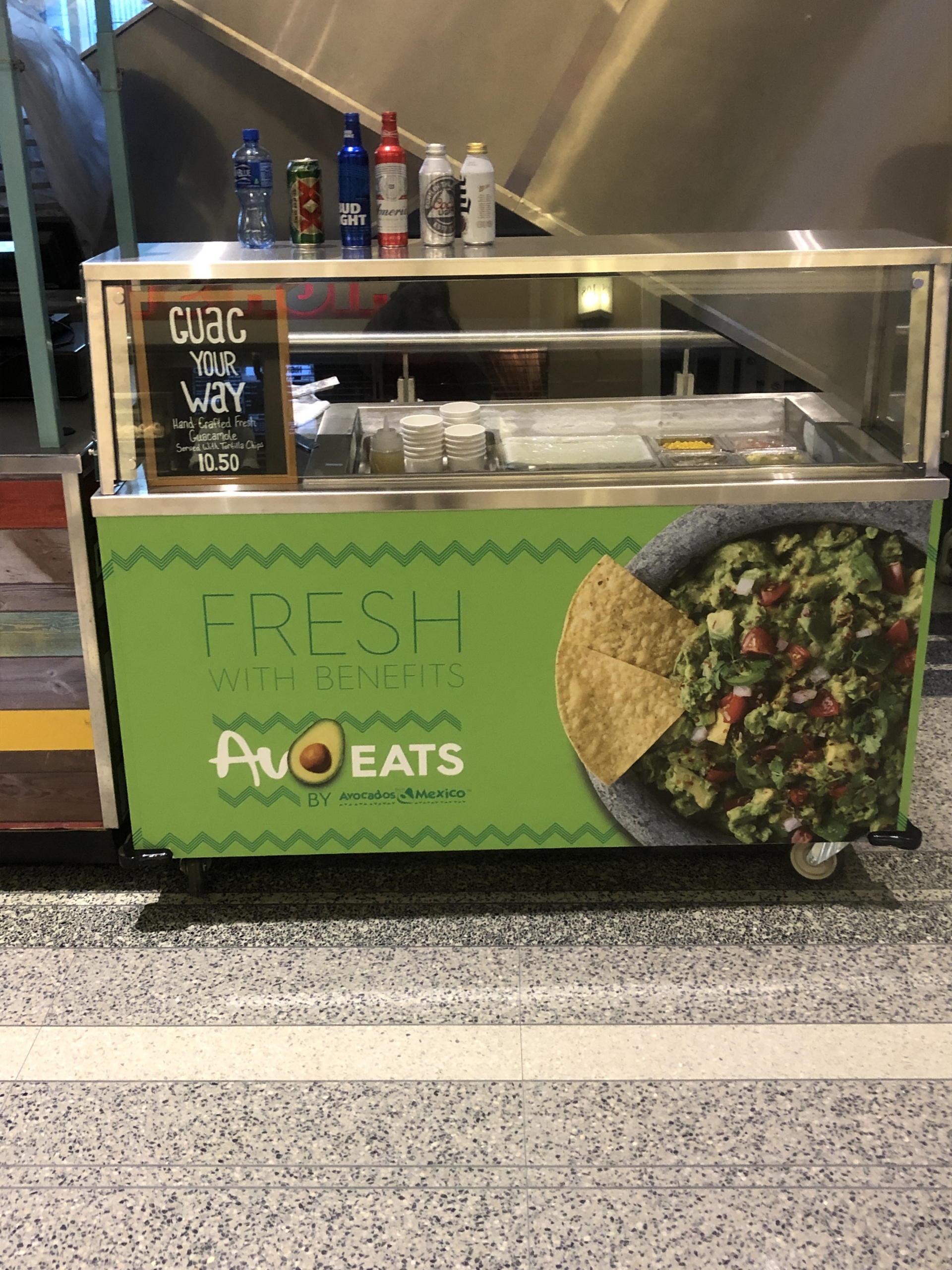 An AvoEats cart in a stadium concourse